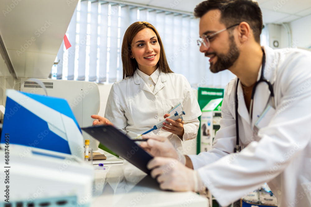 Fototapeta premium Veterinarians working in laboratory. Vet doctors are examining sample at animal hospital.