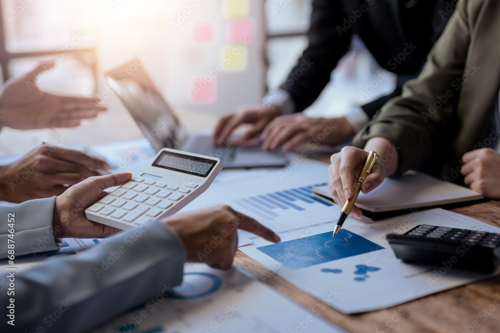 Fototapeta premium Business people meeting. Close up of hands business people working together in meeting, brainstorming, discussing and analyzing and planning business strategy.