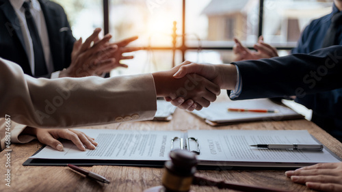 Businessman handshake to seal a deal with his partner lawyers or attorneys discussing a contract agreement. photo