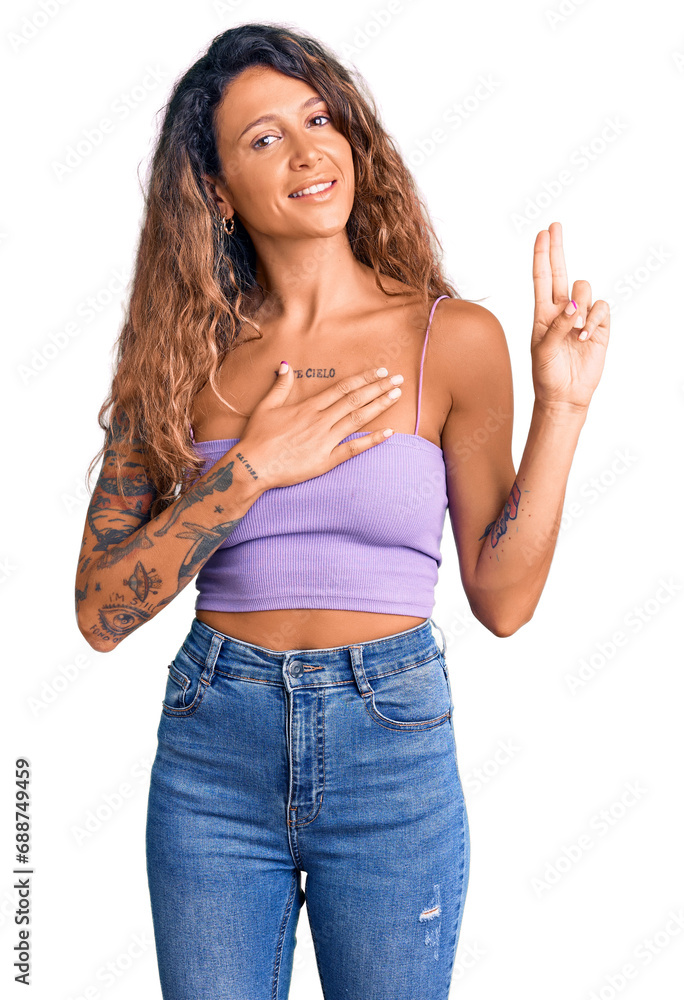 Young hispanic woman with tattoo wearing casual clothes smiling swearing with hand on chest and fingers up, making a loyalty promise oath Young hispanic woman with tattoo wearing casual clothes smiling swearing with hand on chest and fingers up, making a loyalty promise oath