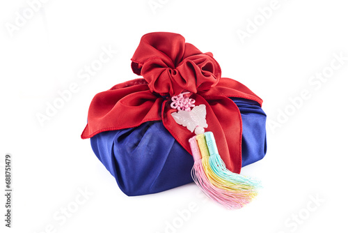 Korean traditional gift packaging cloth made of silk bojagi and ornaments Isolated on white background photo