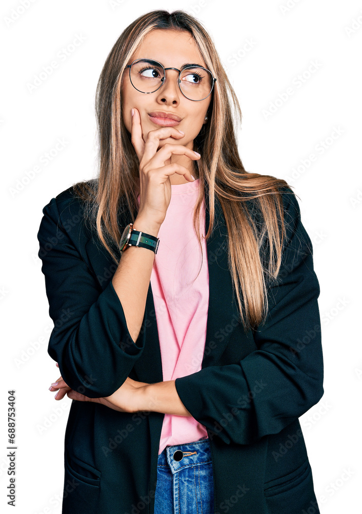 Hispanic young woman wearing business jacket and glasses with hand on chin thinking about question, pensive expression. smiling with thoughtful face. doubt concept. Hispanic young woman wearing business jacket and glasses with hand on chin thinking about question, pensive expression. smiling with thoughtful face. doubt concept.