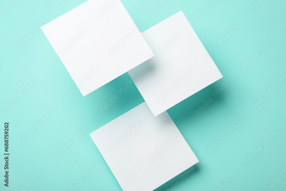 Composition of floating white square memo papers on blue background. Business concept Composition of floating white square memo papers on blue background. Business concept
