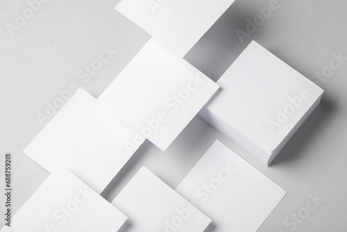 Composition of floating white square memo papers on gray background. Business concept
