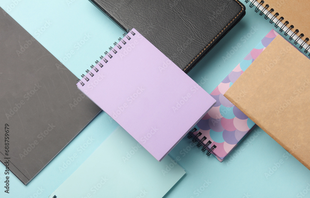 Composition of floating notepads on a blue background Composition of floating notepads on a blue background