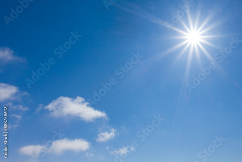 sparkle sun on blue cloudy sky background