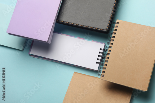 Composition of floating notepads on a blue background