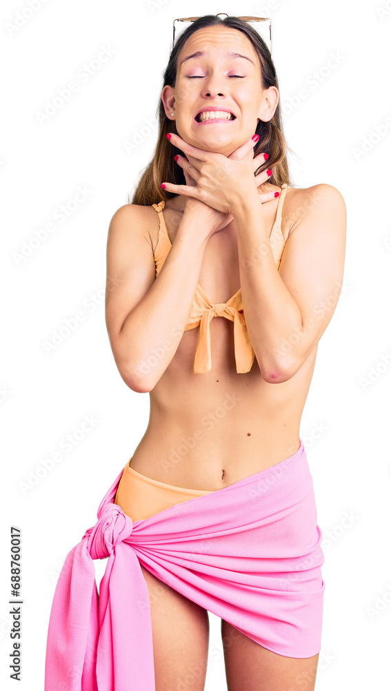 Fototapeta premium Beautiful brunette young woman wearing bikini and sunglasses shouting and suffocate because painful strangle. health problem. asphyxiate and suicide concept.