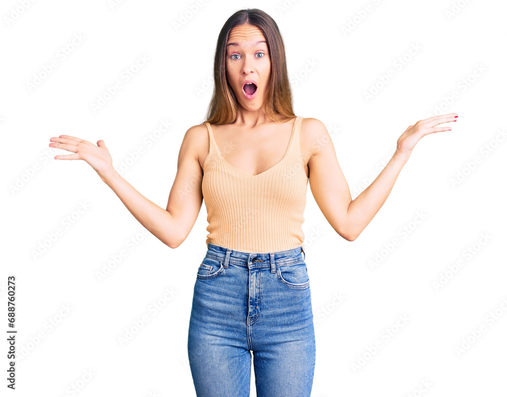 Beautiful brunette young woman wearing casual clothes celebrating victory with happy smile and winner expression with raised hands Beautiful brunette young woman wearing casual clothes celebrating victory with happy smile and winner expression with raised hands