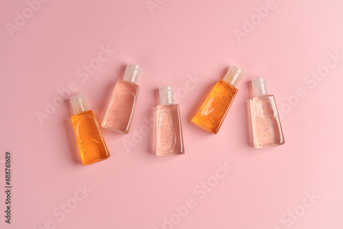 Antiseptic bottles on a pink background