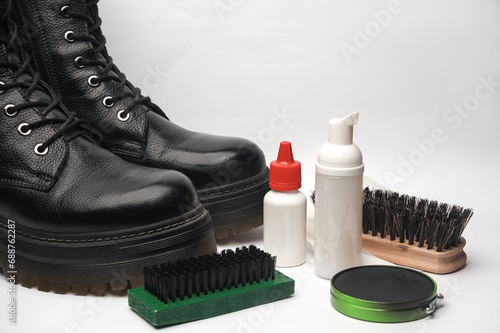 Leather boots and Shoe care products or accessories on a white background