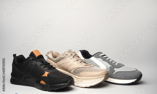 Three different sports sneakers on a gray background
