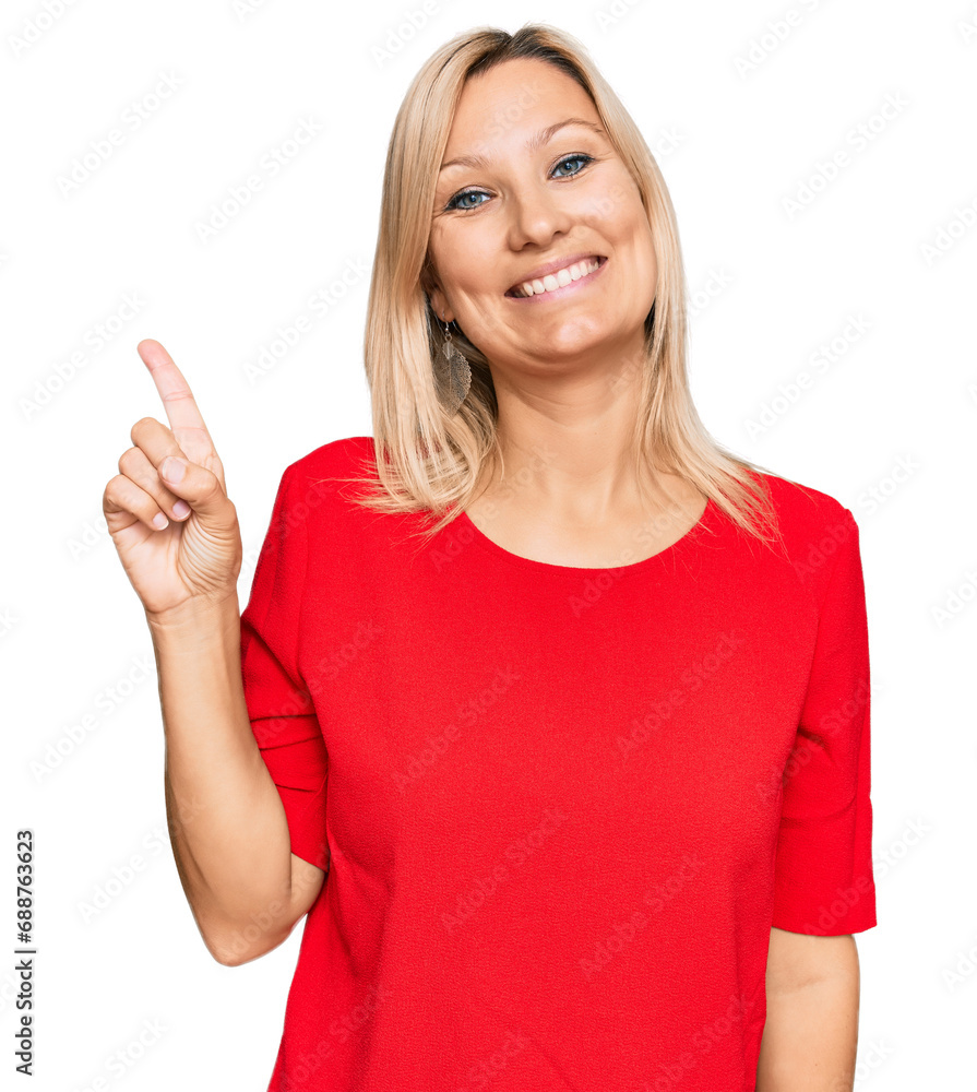 Middle age caucasian woman wearing casual clothes showing and pointing up with finger number one while smiling confident and happy. Middle age caucasian woman wearing casual clothes showing and pointing up with finger number one while smiling confident and happy.