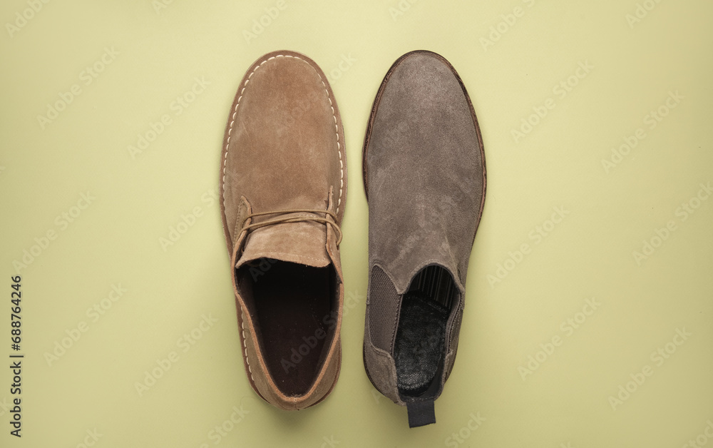 Fototapeta premium Suede desert and Chelsea boots on green background