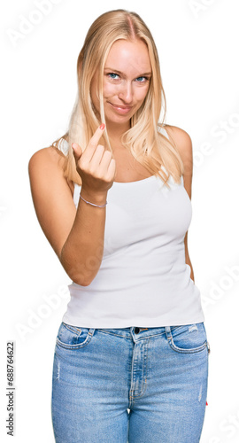 Young blonde girl wearing casual style with sleeveless shirt beckoning come here gesture with hand inviting welcoming happy and smiling