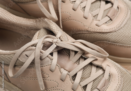 Close-up laces of beige sports sneakers