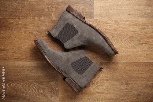 Pair of gray suede Chelsea boots on the floor. Top view