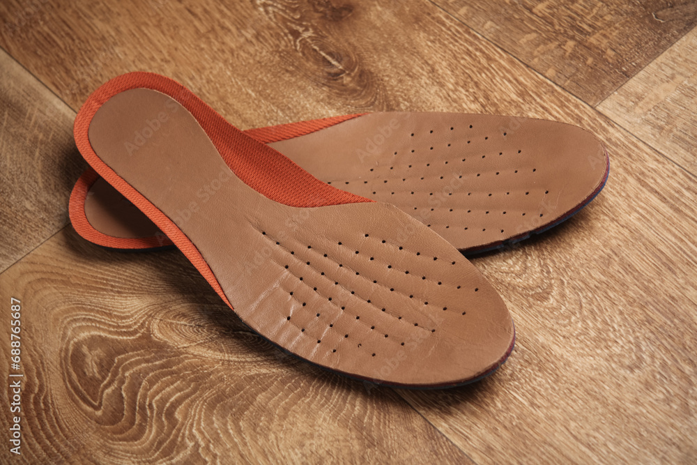 Leather insoles on a wooden floor Leather insoles on a wooden floor