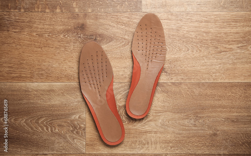 Leather insoles on a wooden floor