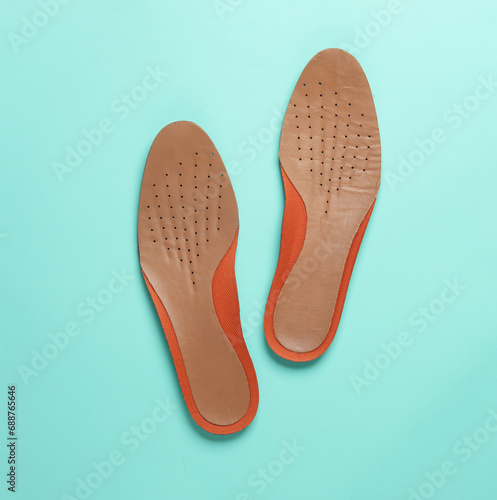 Leather insoles on a blue background