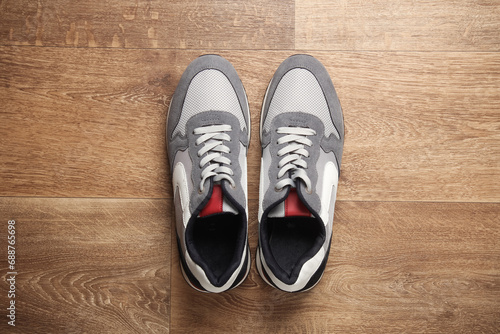 Sports sneakers on wooden floor. Top view