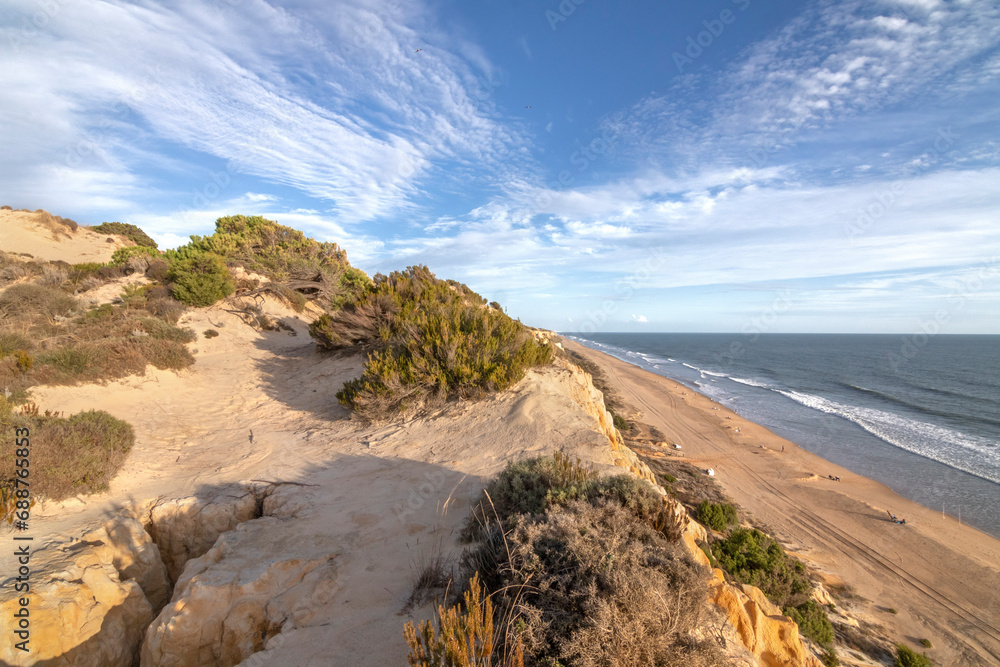 El Arenosillo beach is characterized by being a virgin beach of fine, golden sand. Its cliffs make it unique. Pure nature, full of pine trees and native vegetation. One of the best beaches in Spain.