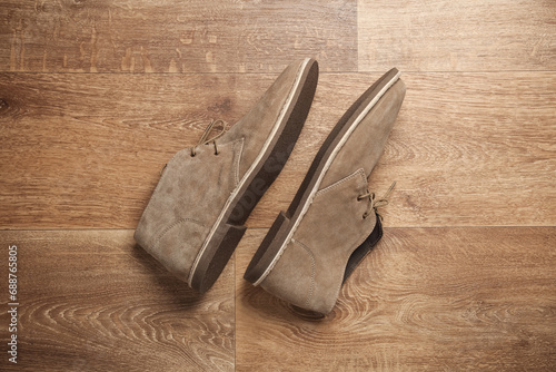 Suede desert shoes on wooden floor