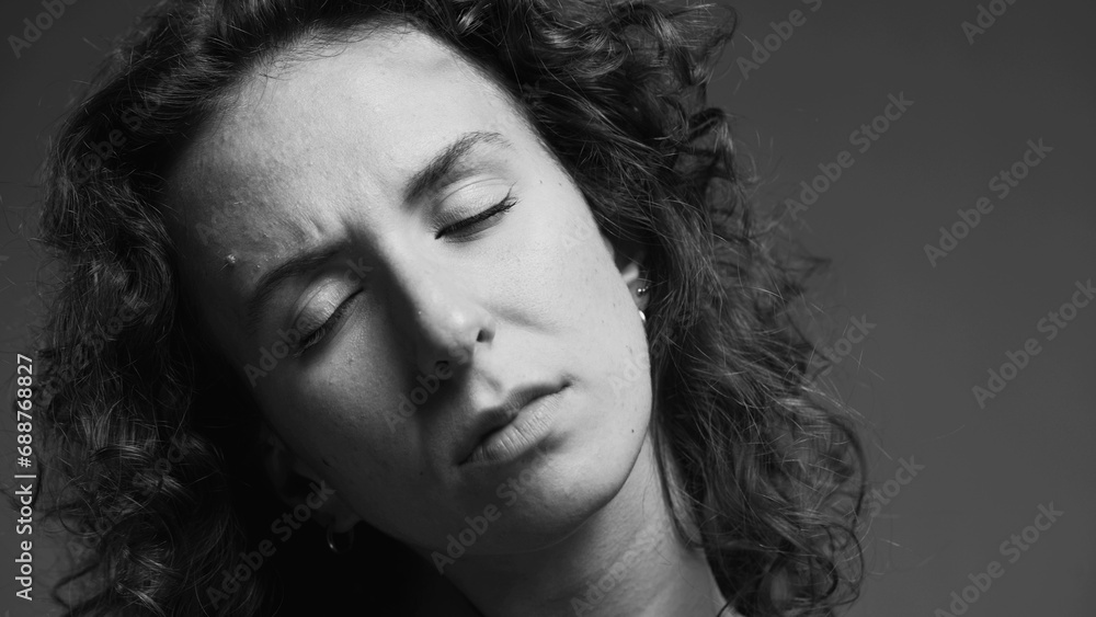 Person experiencing stiff neck, woman having body pain in black and white Person experiencing stiff neck, woman having body pain in black and white