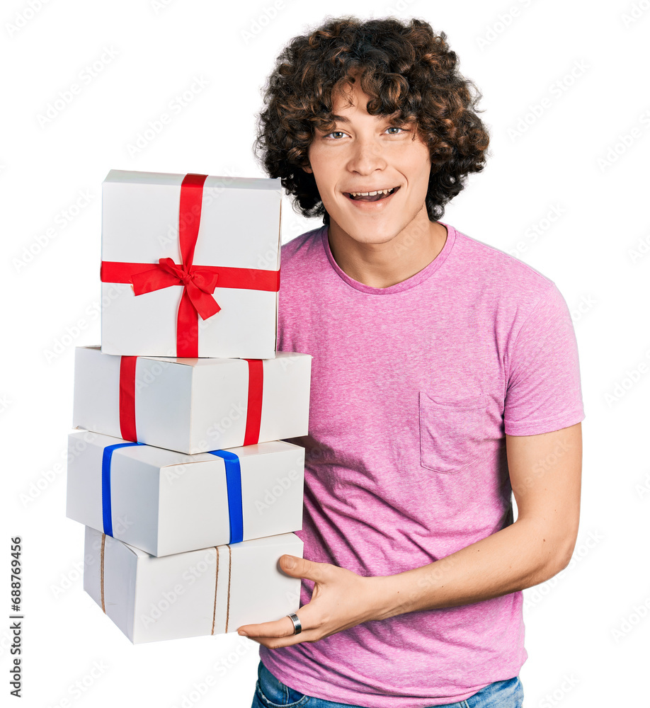 Caucasian teenager holding gifts smiling and laughing hard out loud because funny crazy joke. Caucasian teenager holding gifts smiling and laughing hard out loud because funny crazy joke.