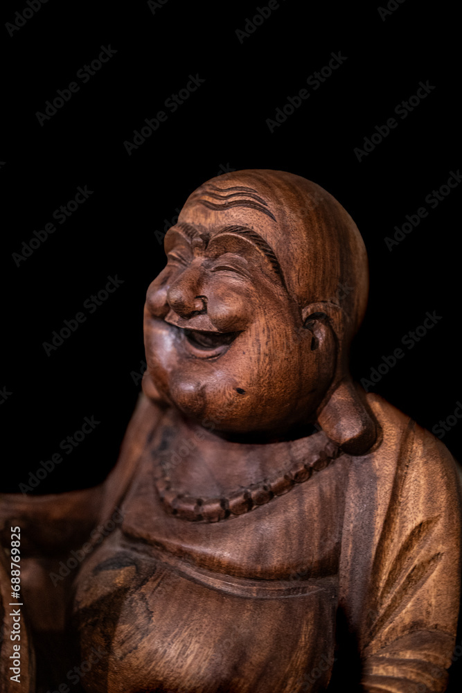 Wooden Buddha with black background Wooden Buddha with black background