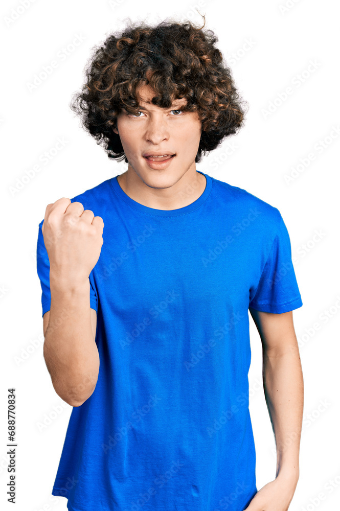 Caucasian teenager wearing casual clothes angry and mad raising fist frustrated and furious while shouting with anger. rage and aggressive concept. Caucasian teenager wearing casual clothes angry and mad raising fist frustrated and furious while shouting with anger. rage and aggressive concept.