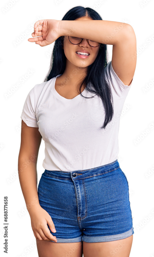 Fototapeta premium Young beautiful asian girl wearing casual clothes and glasses covering eyes with arm smiling cheerful and funny. blind concept.