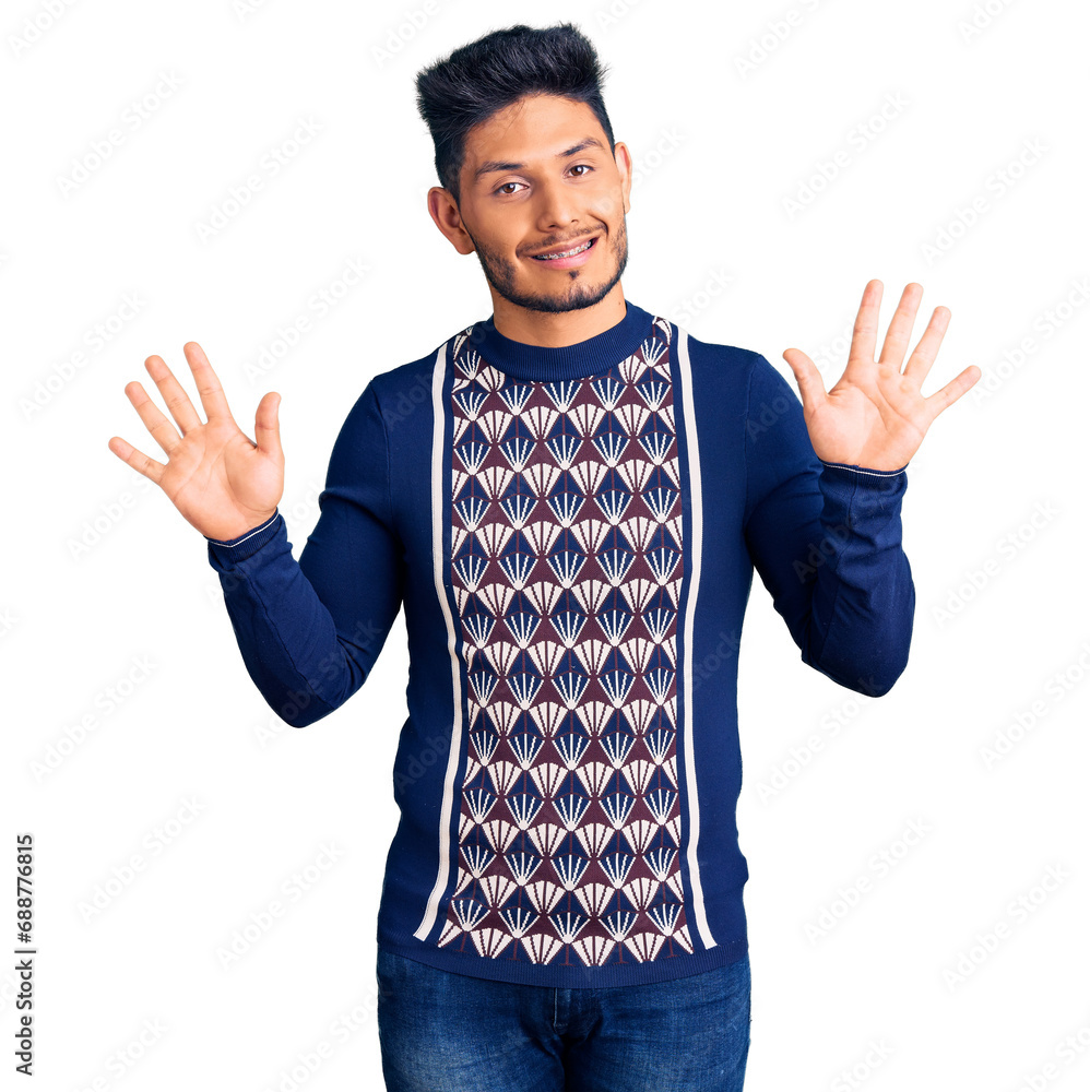 Handsome latin american young man wearing casual winter sweater showing and pointing up with fingers number ten while smiling confident and happy. Handsome latin american young man wearing casual winter sweater showing and pointing up with fingers number ten while smiling confident and happy.