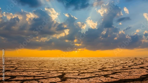 dry cracked waterless plain at the sunset, dramatic ecological disaster time lapse scene photo