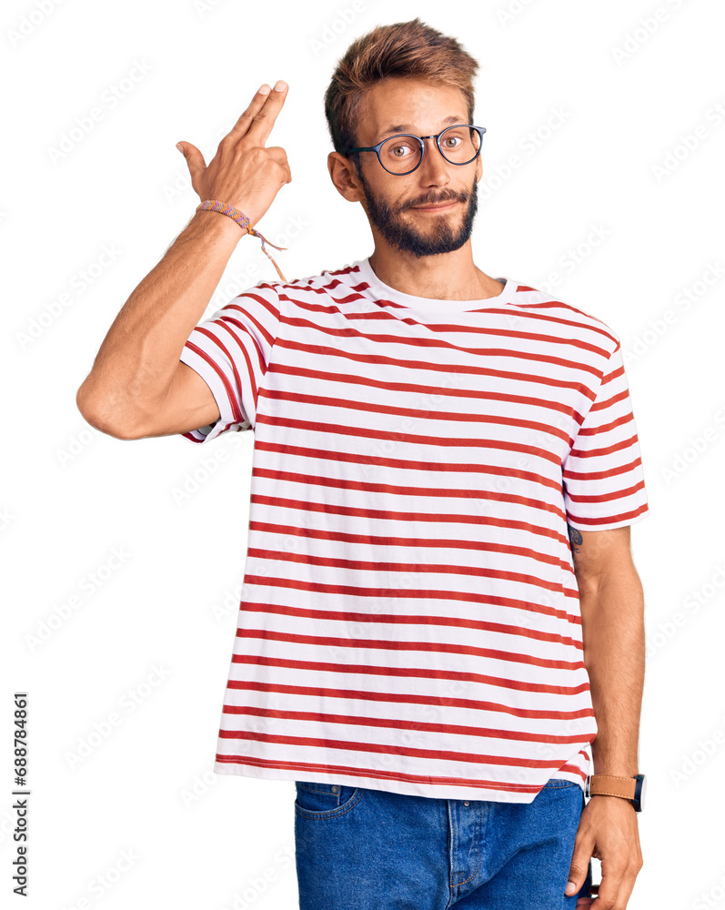 Handsome blond man with beard wearing casual clothes and glasses shooting and killing oneself pointing hand and fingers to head like gun, suicide gesture. Handsome blond man with beard wearing casual clothes and glasses shooting and killing oneself pointing hand and fingers to head like gun, suicide gesture.