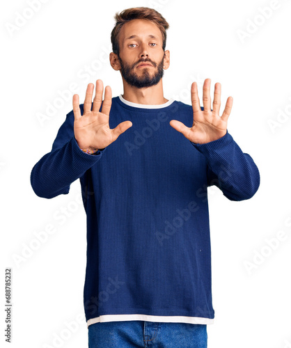 Handsome blond man with beard wearing casual sweater moving away hands palms showing refusal and denial with afraid and disgusting expression. stop and forbidden. © Krakenimages.com