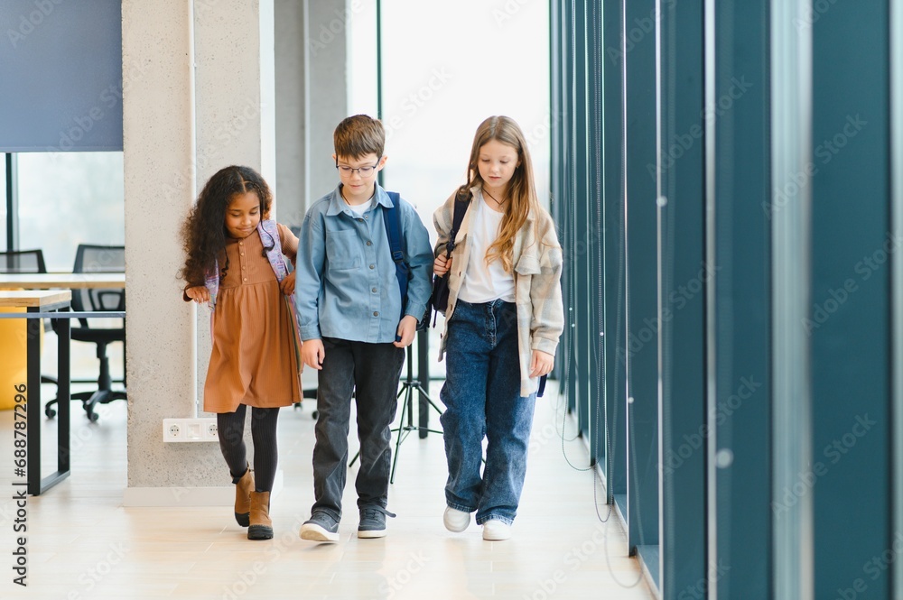 Fototapeta premium Portrait of kids standing in elementary school hallway