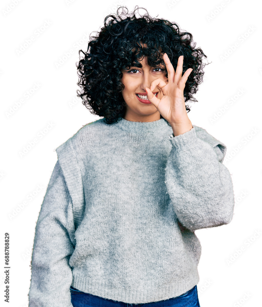 Young middle east girl wearing casual clothes smiling positive doing ok sign with hand and fingers. successful expression. Young middle east girl wearing casual clothes smiling positive doing ok sign with hand and fingers. successful expression.