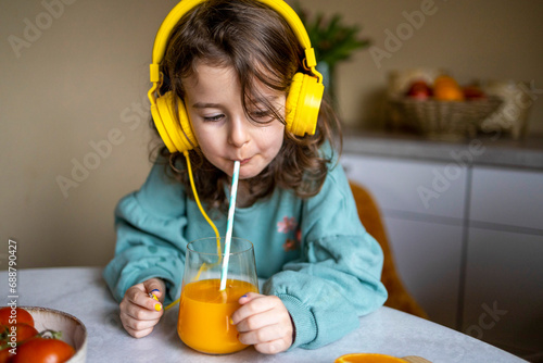 Caucasian child having juice at home photo