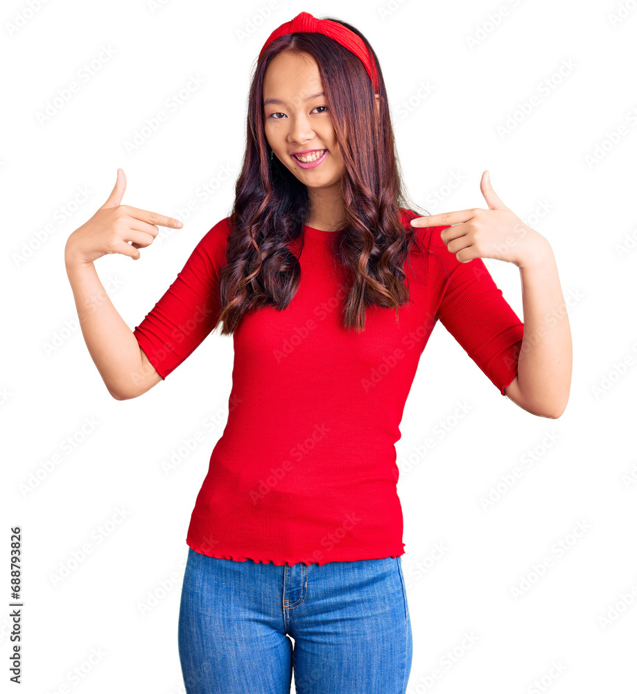 Young beautiful chinese girl wearing casual clothes and diadem looking confident with smile on face, pointing oneself with fingers proud and happy. Young beautiful chinese girl wearing casual clothes and diadem looking confident with smile on face, pointing oneself with fingers proud and happy.
