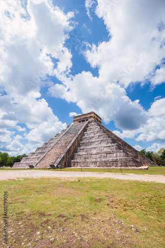 Ancient Mayan Pyramid of Kukulkan at Chichen Itza under a dramatic sky in Mexico. photo