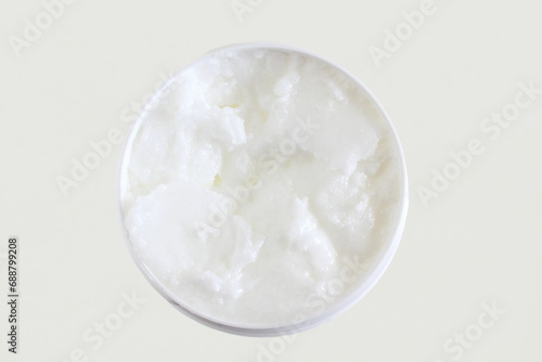 organic coconut cream oil in jar in white background,top view