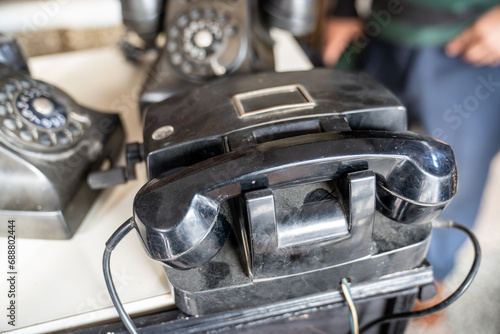 Old magneto analog telephone in an antique shop. Home and business phone in black.