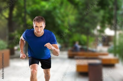 Cheerful and successful man jogging outdoor
