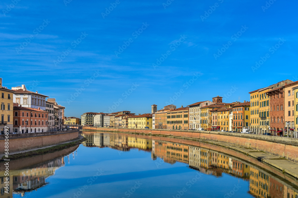 Pisa, Italy - view of the Arno River as seen from the Ponte di Mezzo bridge with the historic buildings of Lungarno Pacinotti