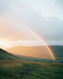 a rainbow over a valley