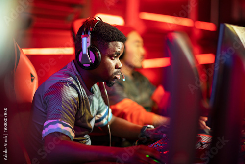 Professional cybersport gamer wearing headphones participating in E-Sports Tournament photo
