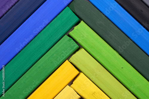 Macro shot of colorful pastel sticks arranged in herringbone pattern