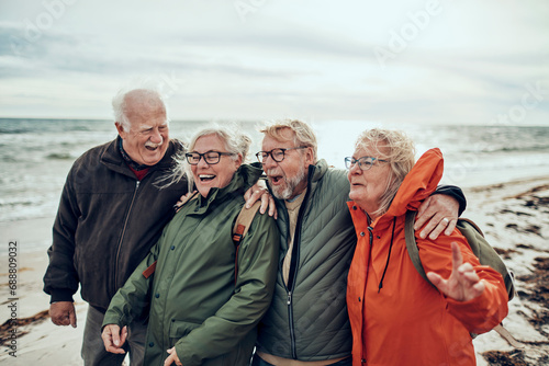 Group of happy senior people on the beach during winter photo