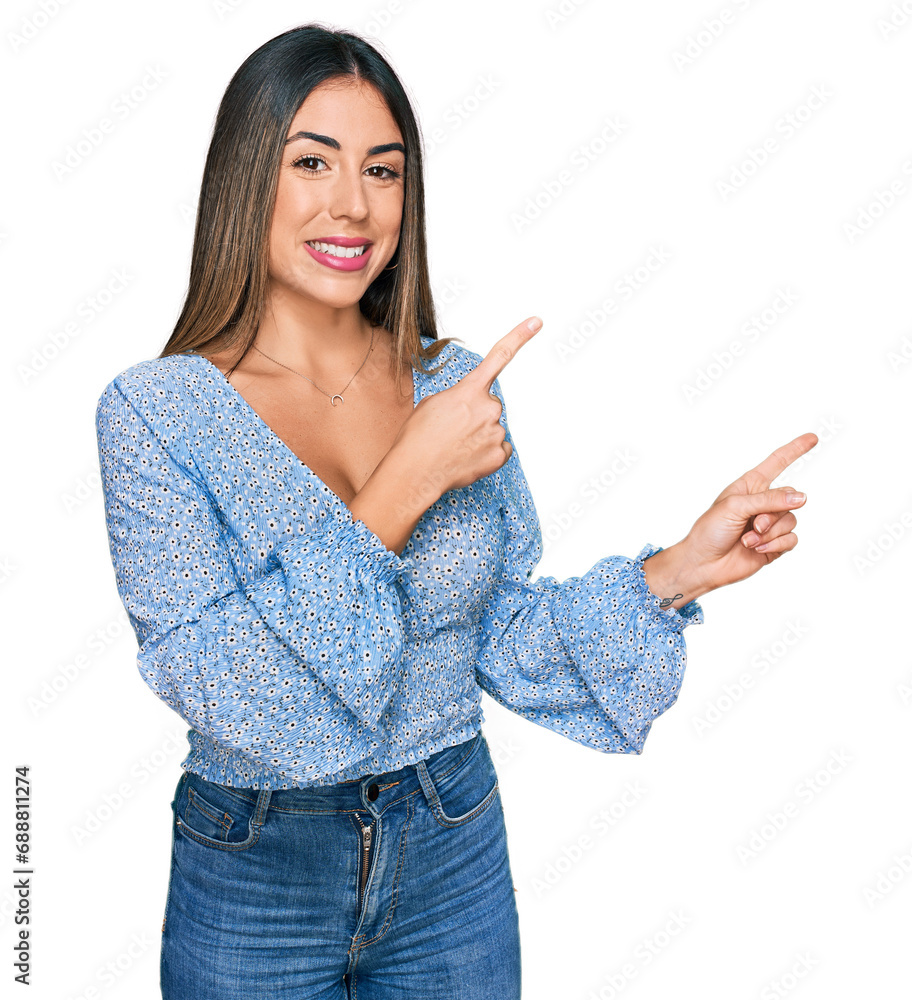 Young hispanic woman wearing casual clothes smiling and looking at the camera pointing with two hands and fingers to the side. Young hispanic woman wearing casual clothes smiling and looking at the camera pointing with two hands and fingers to the side.